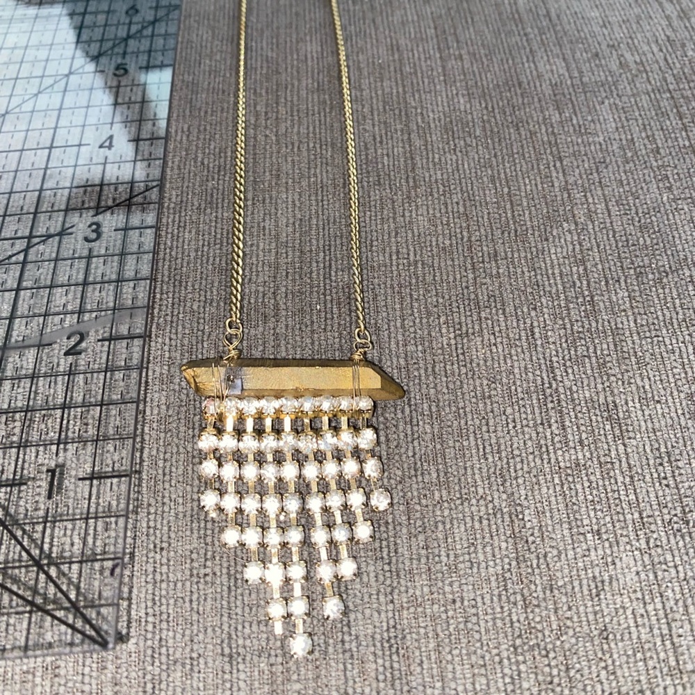 Gold triangular pendant shaped necklace